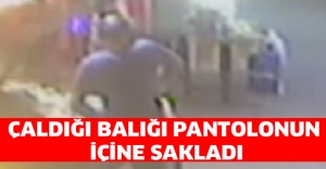 Çaldığı balığı pantolonun içine sakladı